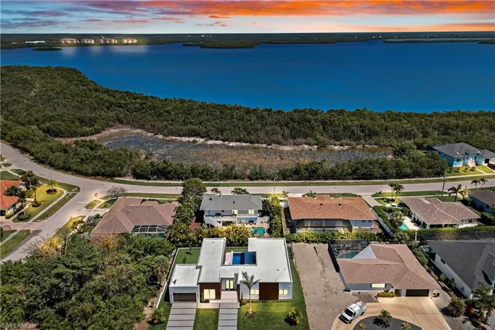 Aerial view at dusk with a residential view and a water view