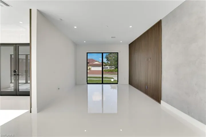 Empty room featuring french doors, visible vents, and recessed lighting