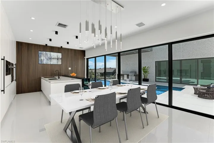 Dining space with wood walls, visible vents, and recessed lighting