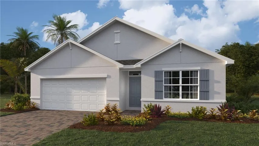 View of front of property with decorative driveway, a garage, stucco siding, and a front yard