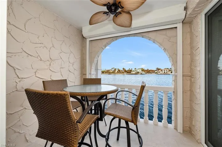 Dining space featuring a water view and a ceiling fan