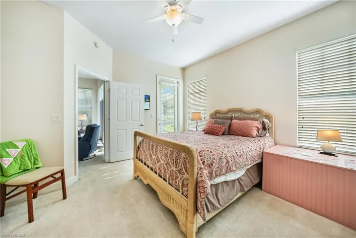 Bedroom with ceiling fan and light colored carpet