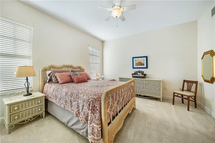 Carpeted bedroom with ceiling fan