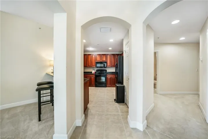 Corridor featuring light tile patterned flooring