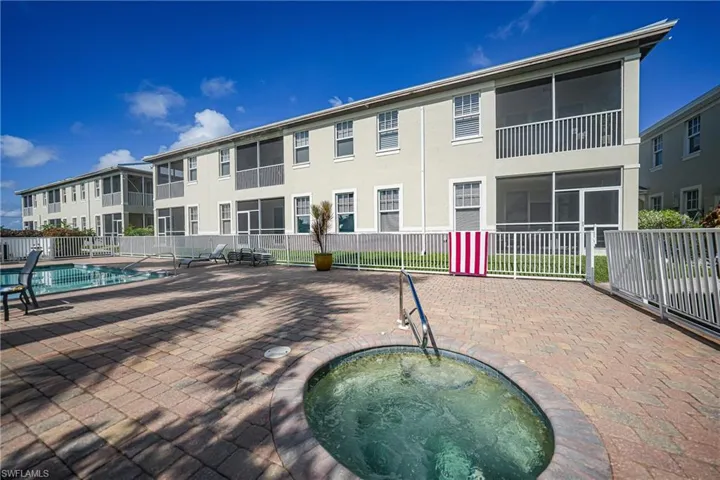 View of pool with a hot tub and a patio area