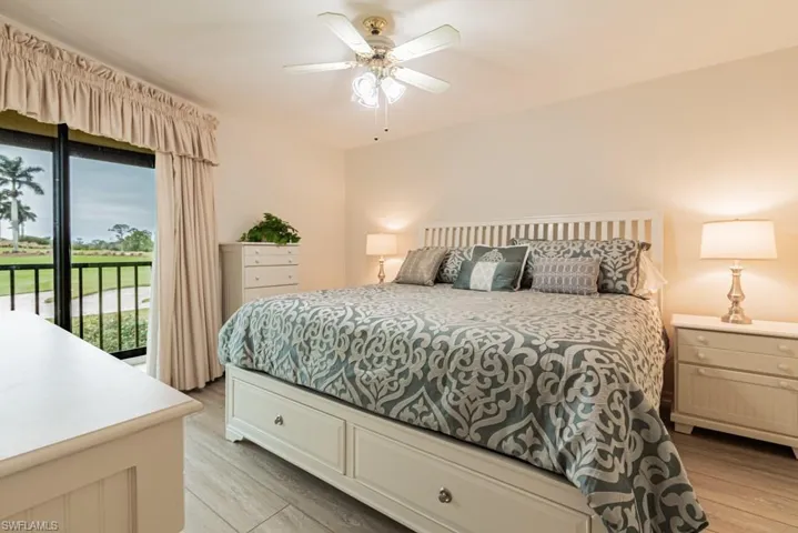 Bedroom featuring access to outside, ceiling fan, and light hardwood / wood-style flooring