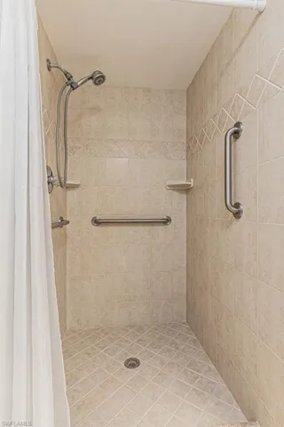 Bathroom with a shower with shower curtain