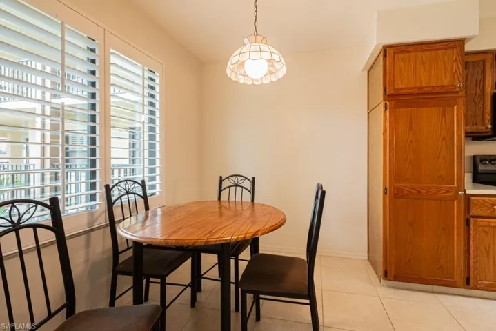 Dining space with light tile patterned floors