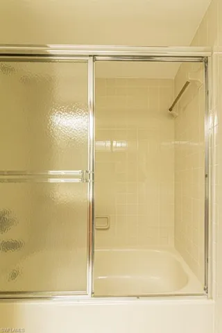 Bathroom with enclosed tub / shower combo