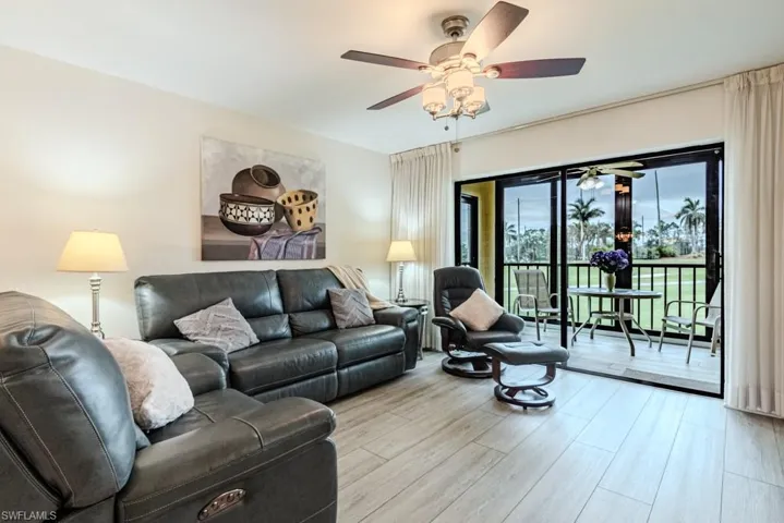 Living room with ceiling fan and light hardwood / wood-style flooring