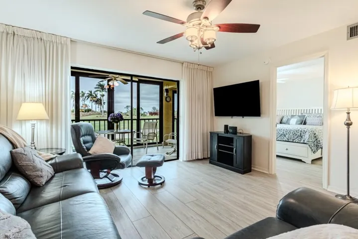 Living room with light wood-type flooring and ceiling fan