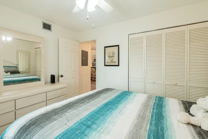 Bedroom with ceiling fan, a closet, and electric panel