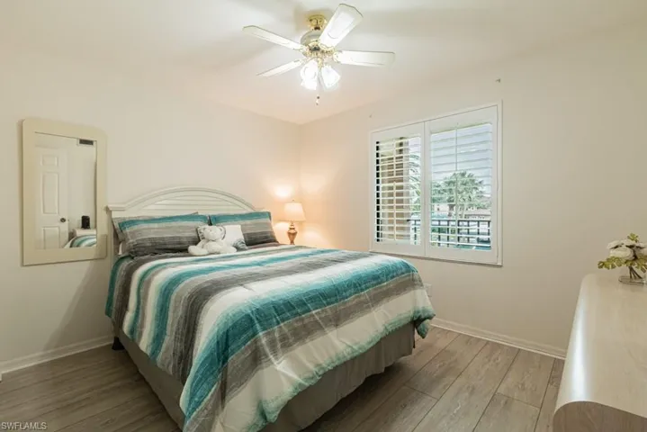 Bedroom featuring ceiling fan and wood-type flooring