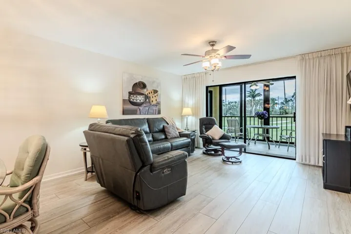Living room featuring ceiling fan and light wood-type flooring