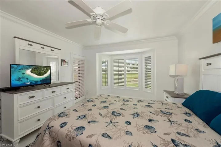 Bedroom with crown molding and a ceiling fan