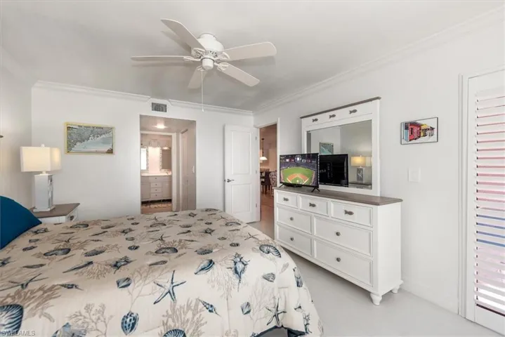 Bedroom featuring crown molding, ensuite bathroom, and ceiling fan
