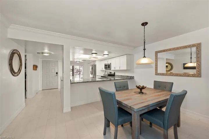 Dining space featuring ornamental molding and baseboards