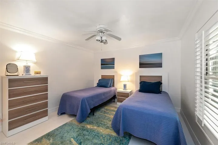 Bedroom with crown molding and a ceiling fan