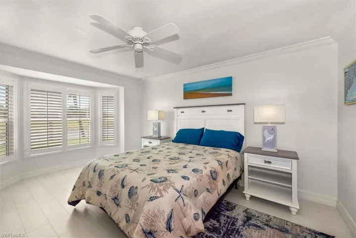 Bedroom featuring ornamental molding and ceiling fan