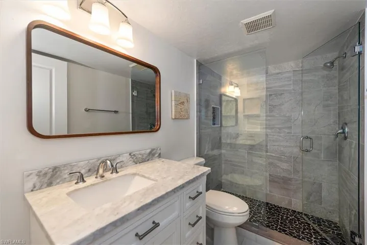 Full bath with vanity and a stall shower