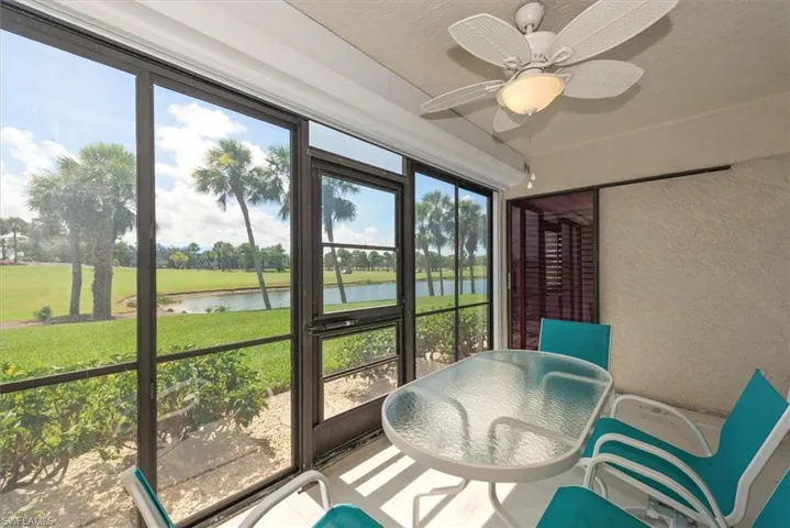 Sunroom with a water view, healthy amount of natural light, and ceiling fan