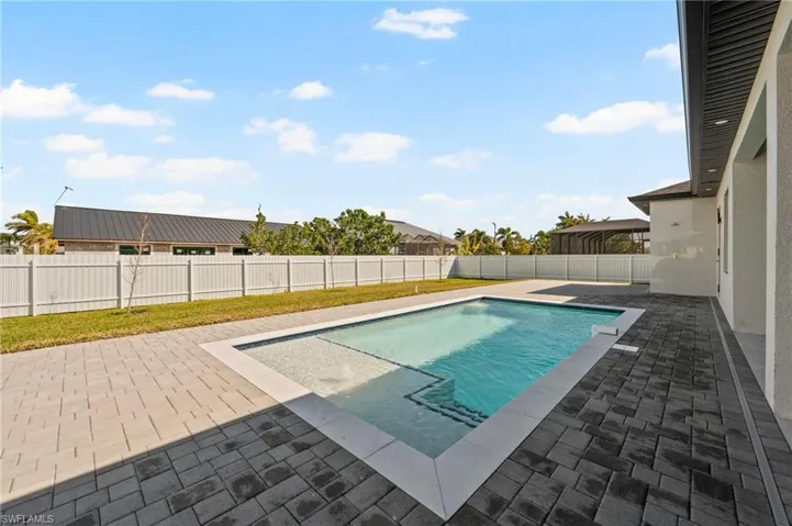 View of swimming pool with a patio, a yard, a fenced backyard, and a fenced in pool