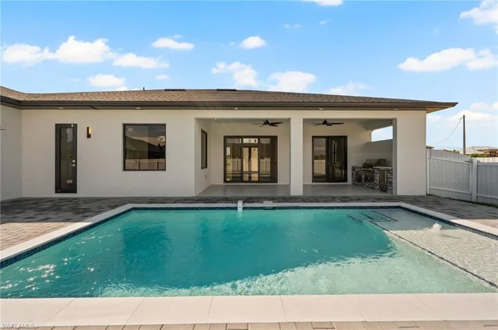 View of pool featuring a patio, fence, a ceiling fan, and a fenced in pool