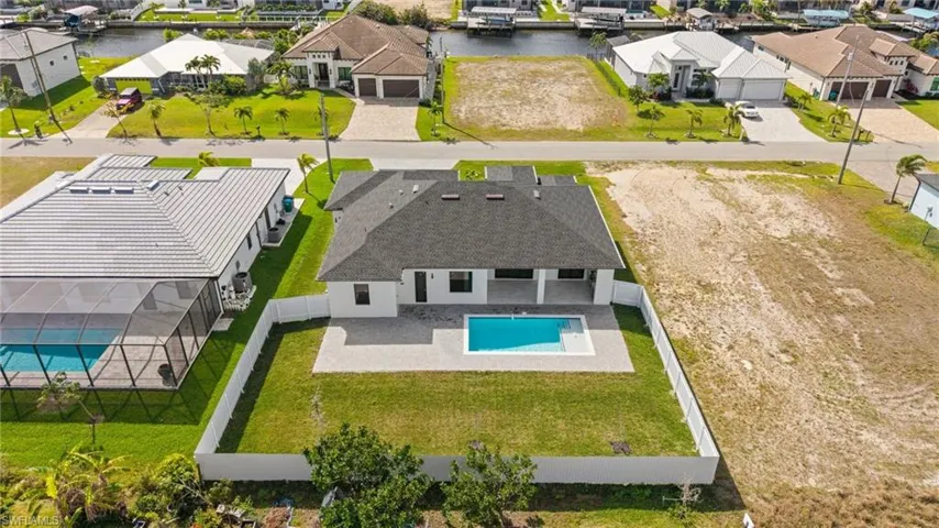 Drone / aerial view with a residential view and a water view
