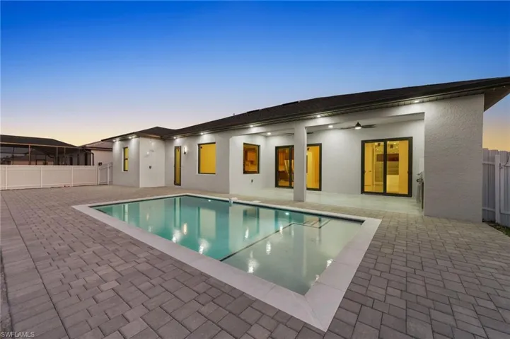 View of swimming pool featuring a patio, fence, and a fenced in pool