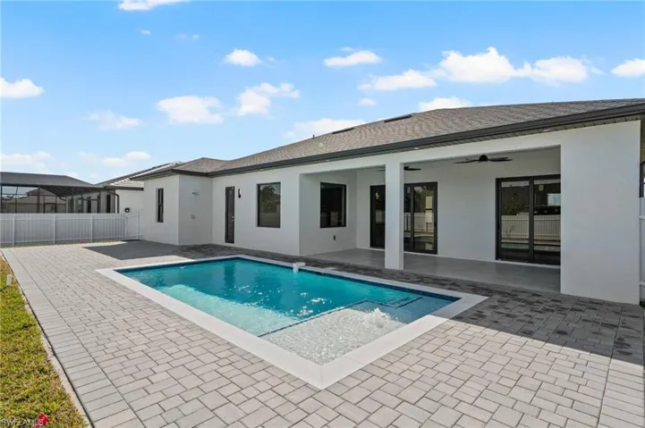 Pool featuring a ceiling fan, a patio, and fence