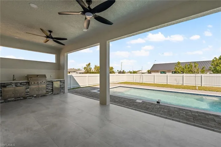 View of swimming pool with a fenced in pool, a patio, a fenced backyard, grilling area, and exterior kitchen