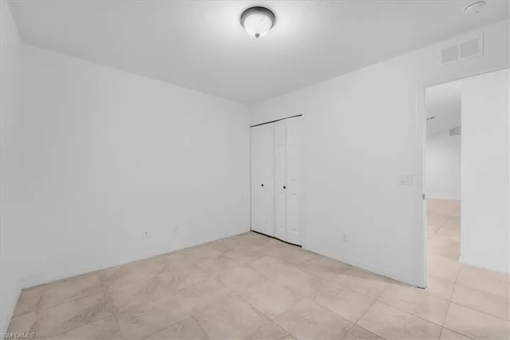 Unfurnished bedroom featuring baseboards and a closet