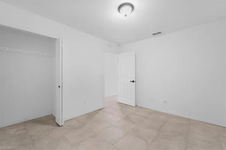 Unfurnished bedroom featuring a closet and baseboards