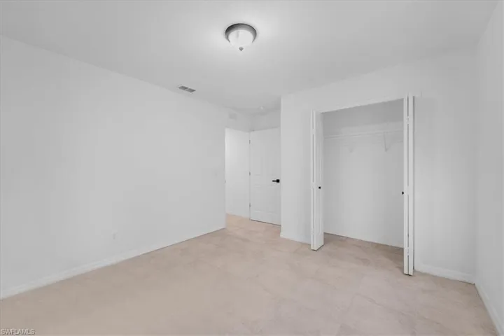 Unfurnished bedroom with a closet and baseboards