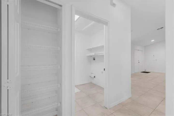 Laundry area featuring light tile patterned floors, recessed lighting, hookup for a gas dryer, and hookup for a washing machine