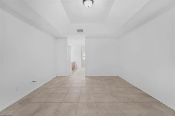 Empty room with a raised ceiling and baseboards