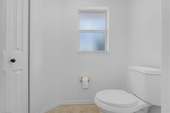 Bathroom with toilet and baseboards