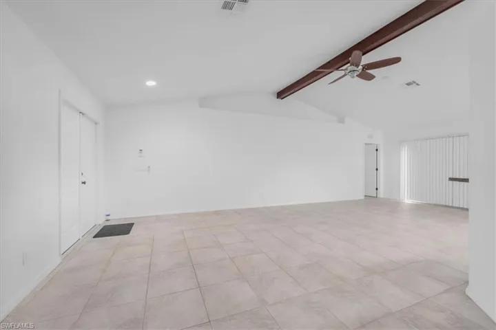 Spare room with ceiling fan, beam ceiling, recessed lighting, and light tile patterned floors