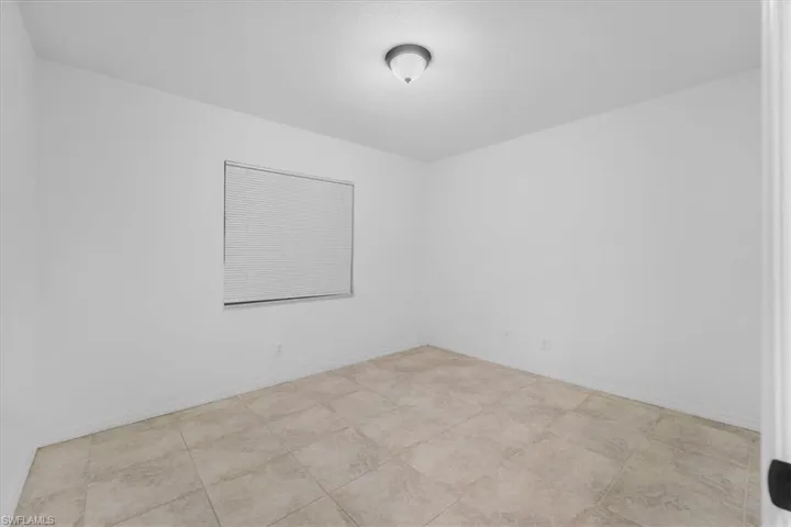 Unfurnished room featuring baseboards