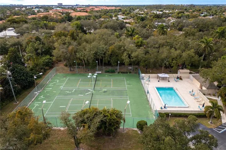 Aerial view of a pool area and a tree filled landscape