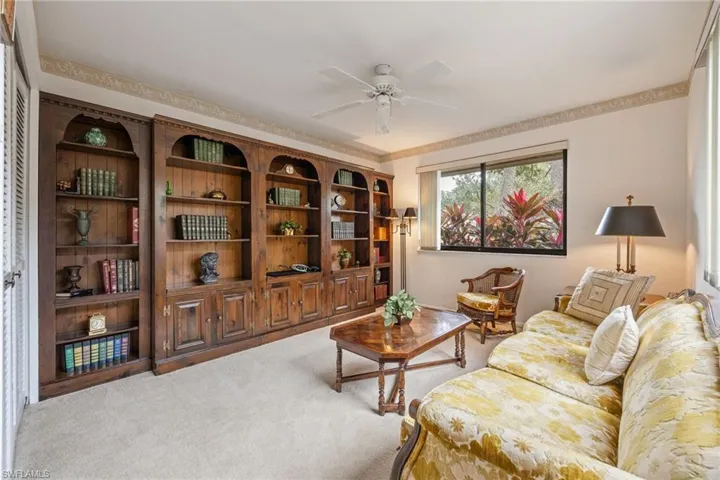 Sitting room featuring light carpet and ceiling fan