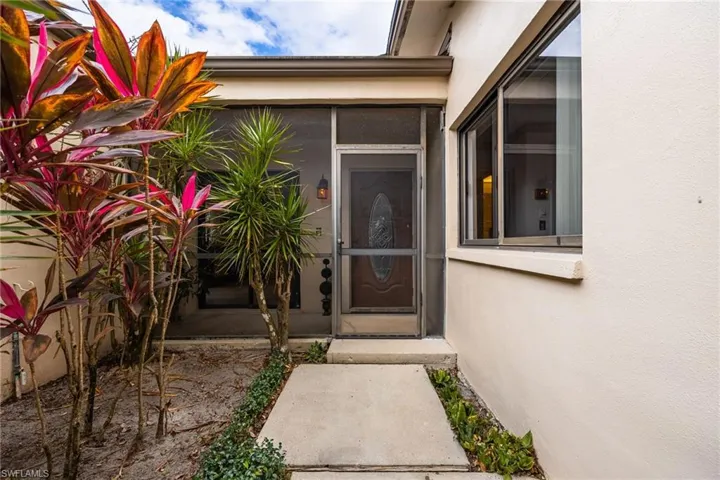 Entrance to property with stucco siding