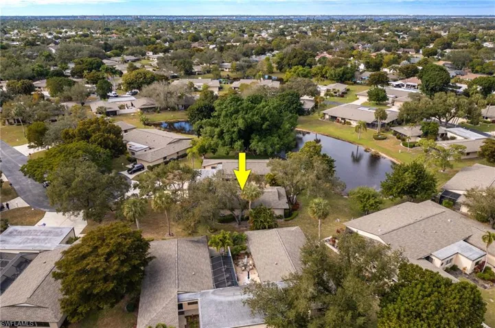 Aerial view of property's location with nearby suburban area and a nearby body of water