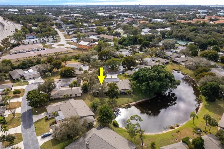 Aerial view of property and surrounding area with nearby suburban area