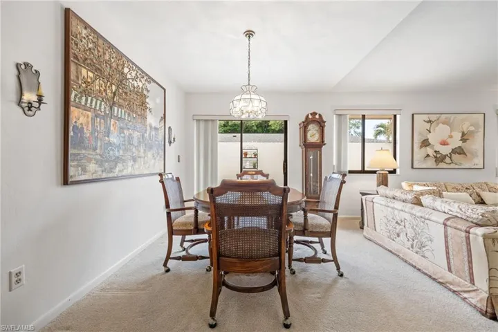 Dining space featuring a chandelier and light carpet
