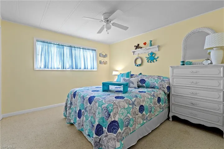 Guest bedroom featuring a ceiling fan and baseboards