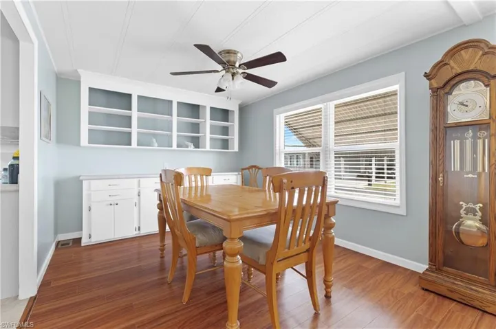 Dining area featuring a ceiling fan, baseboards, and light wood-style floors