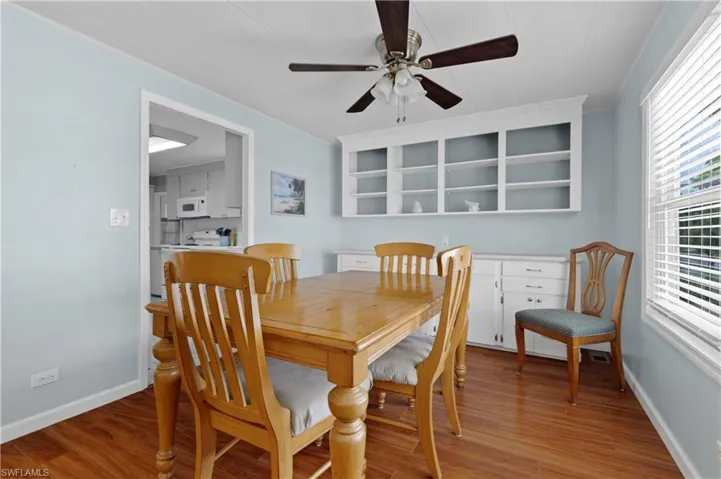 Dining room with baseboards, light wood-type flooring, and a ceiling fan