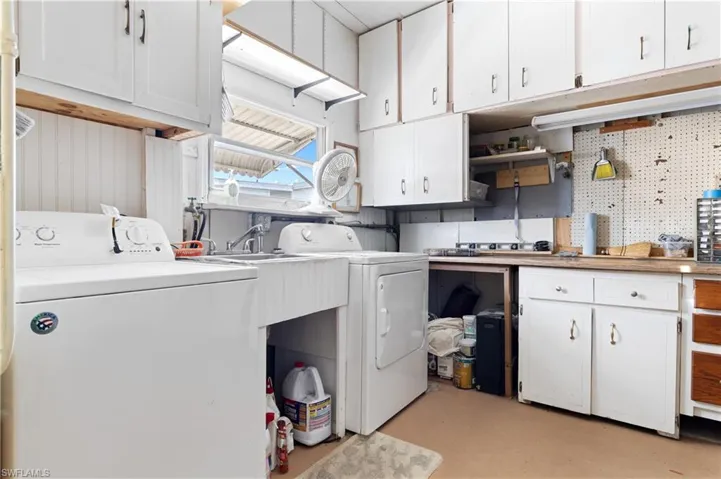 Second laundry, primary laundry is located in the residence. Work bench and storage.