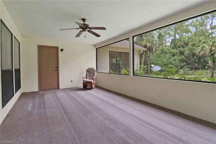 Unfurnished sunroom with ceiling fan